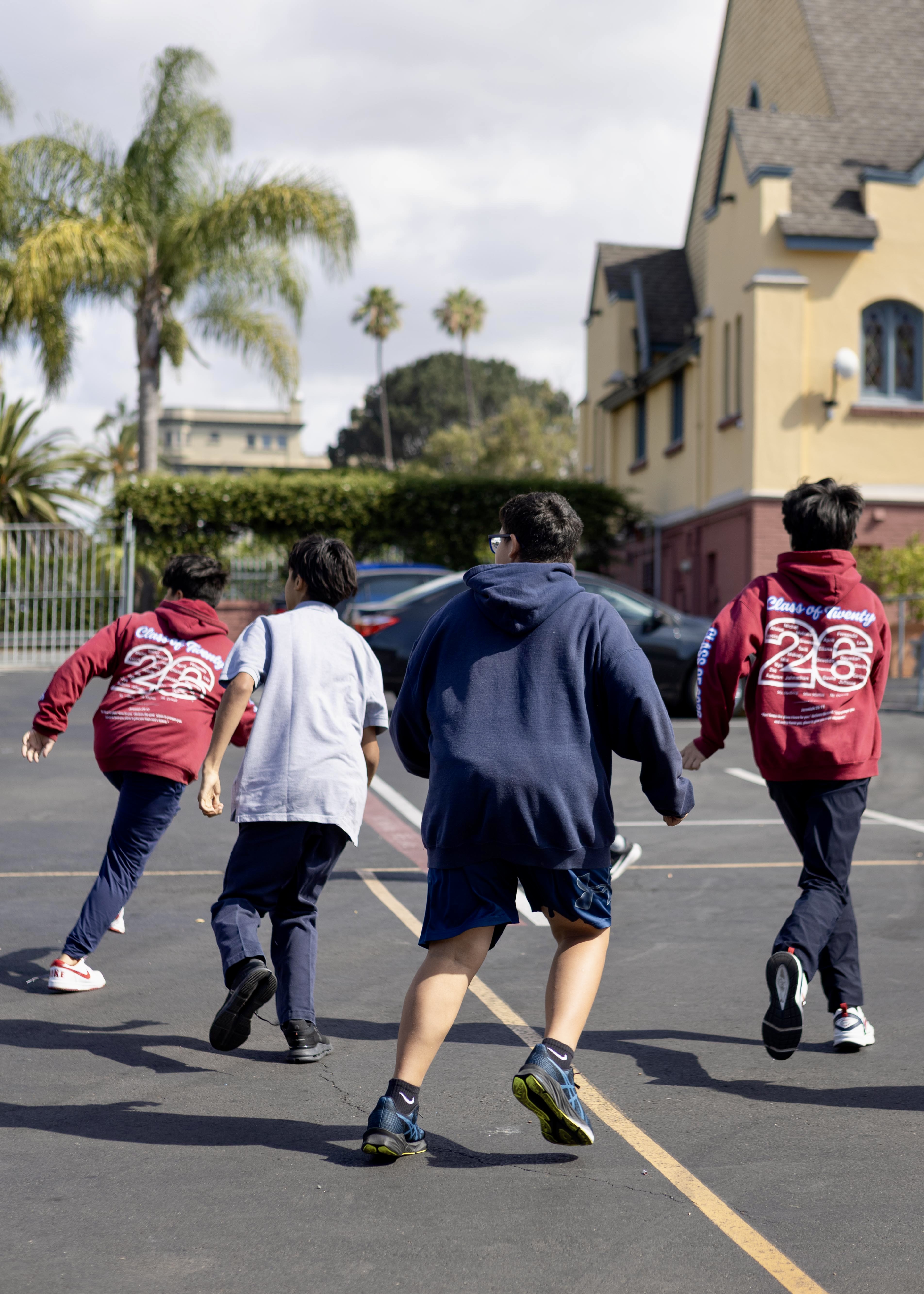 Young teenage boys playing basketball.